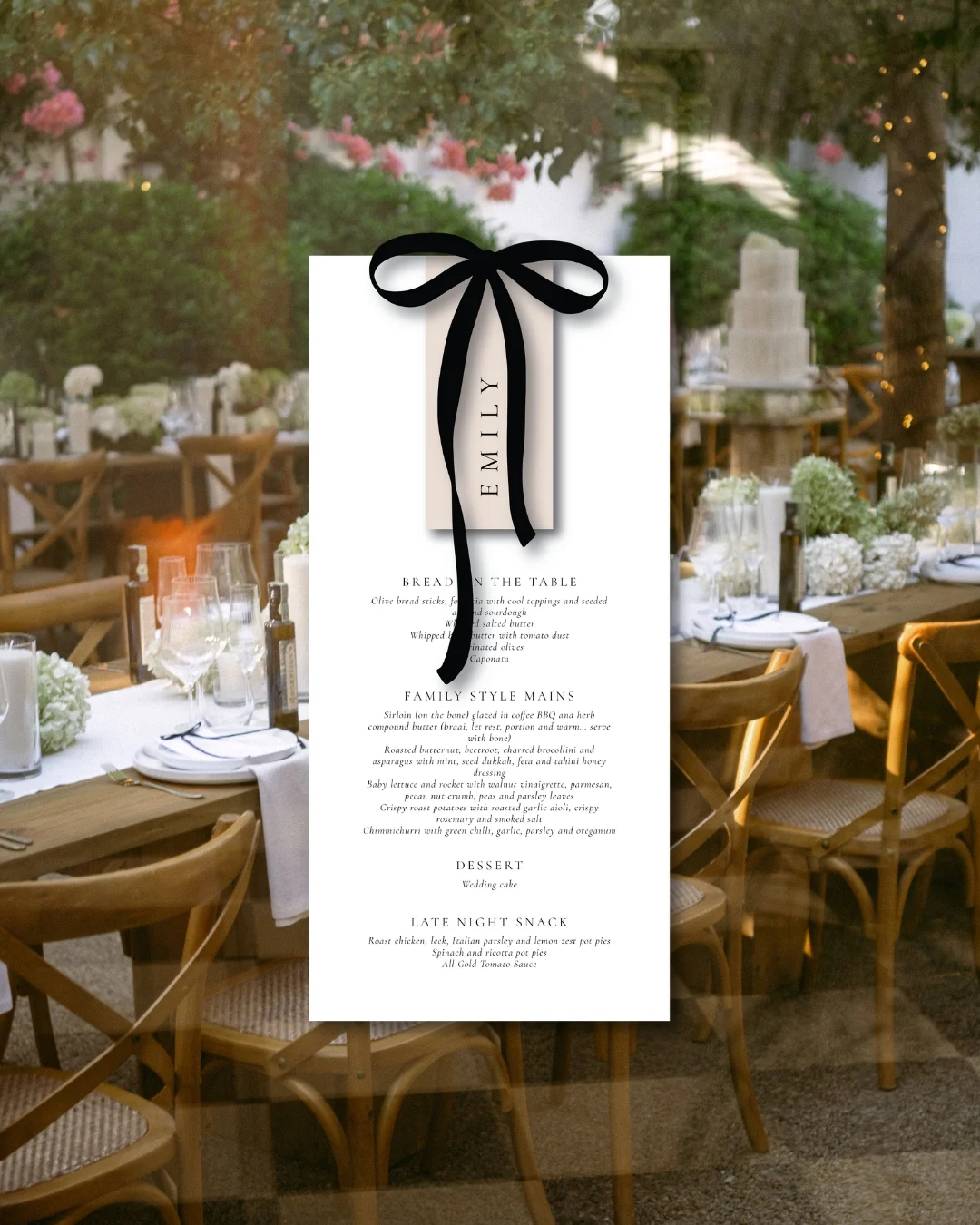 Wedding menu card tied with a black ribbon on a reception table